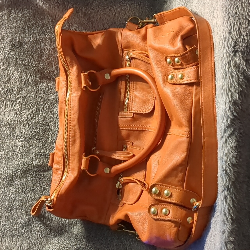 Linea Pelle large orange purse.
